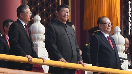 Chinese President Xi Jinping, center, attends a military parade with former presidents Hu Jintao, left, and Jiang Zemin in Tiananmen Square in Beijing on October 1, 2019.