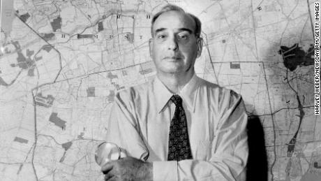 Robert Moses stands in front of map of Long Island, New York, in 1954.