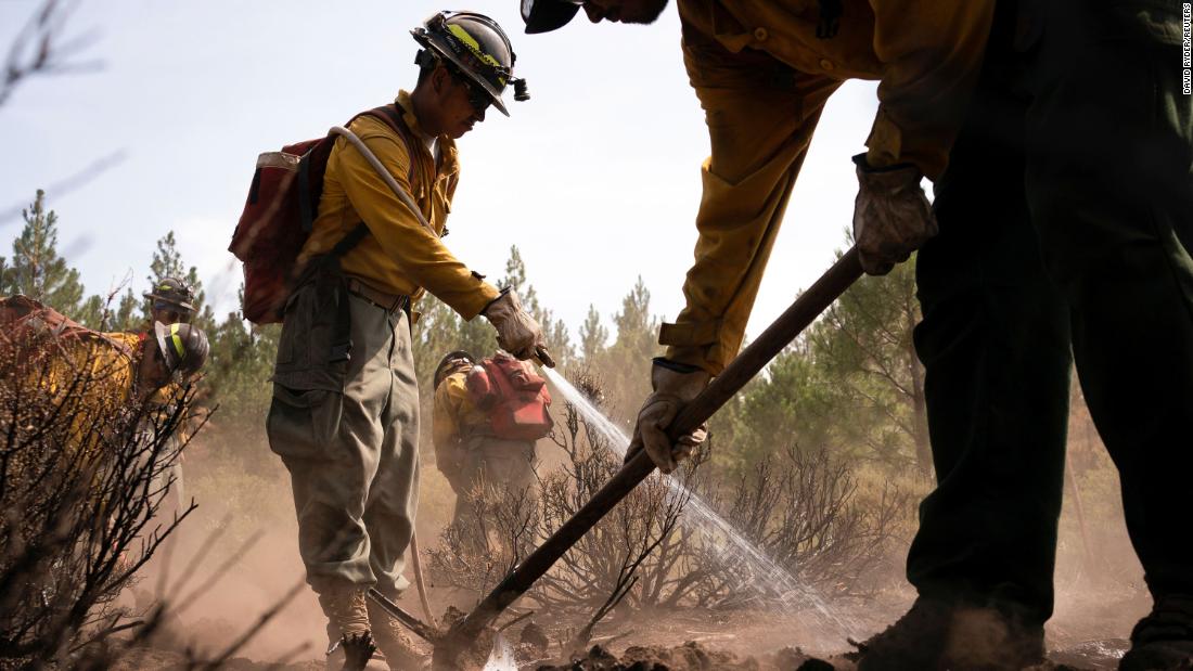 Firefighters extinguish hot spots in an area affected by the Bootleg Fire near Bly, Oregon.