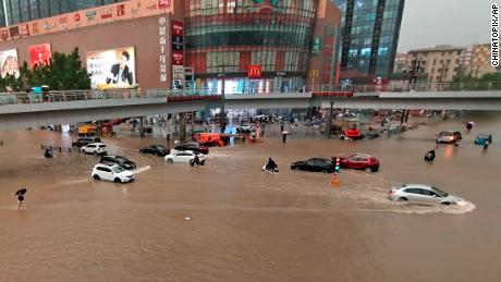 Vehicles are stranded after a heavy downpour in Zhengzhou city, central China&#39;s Henan province on Tuesday. 