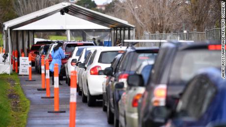 Cars wait in line at a drive-through Covid-19 testing facility in Melbourne, July 21, 2021. 