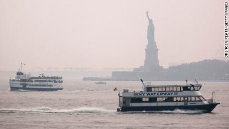 The Statue of Liberty sits behind a cloud of haze on July 20, 2021, in New York City. According the National Oceanic and Atmospheric Administration, wildfire smoke from wildfires has arrived in the tri-state area creating decreased visibility and a yellowish haze in many areas.