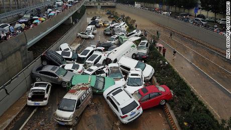 Cars sit in floodwaters at the entrance of a tunnel after heavy rains hit the city of Zhengzhou on July 22, 2021.