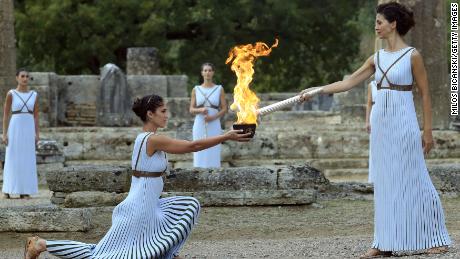 OLYMPIA, GREECE - OCTOBER 24: High priestess passes the Olympic flame at the Temple of Hera  during a   lighting ceremony of the Olympic flame in ancient Olympia on October 24, 2017 in Olympia, Greece. The flame will be transported by torch relay to the Pyeongchang, South Korea, which will host the 2018 Winter Olympics. (Photo by Milos Bicanski/Getty Images)
