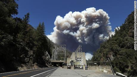 Heavy plumes of smoke billow from the Dixie fire above the Plumas National Forest near the Pacific Gas and Electric (PG&amp;E) Rock Creek Power House.