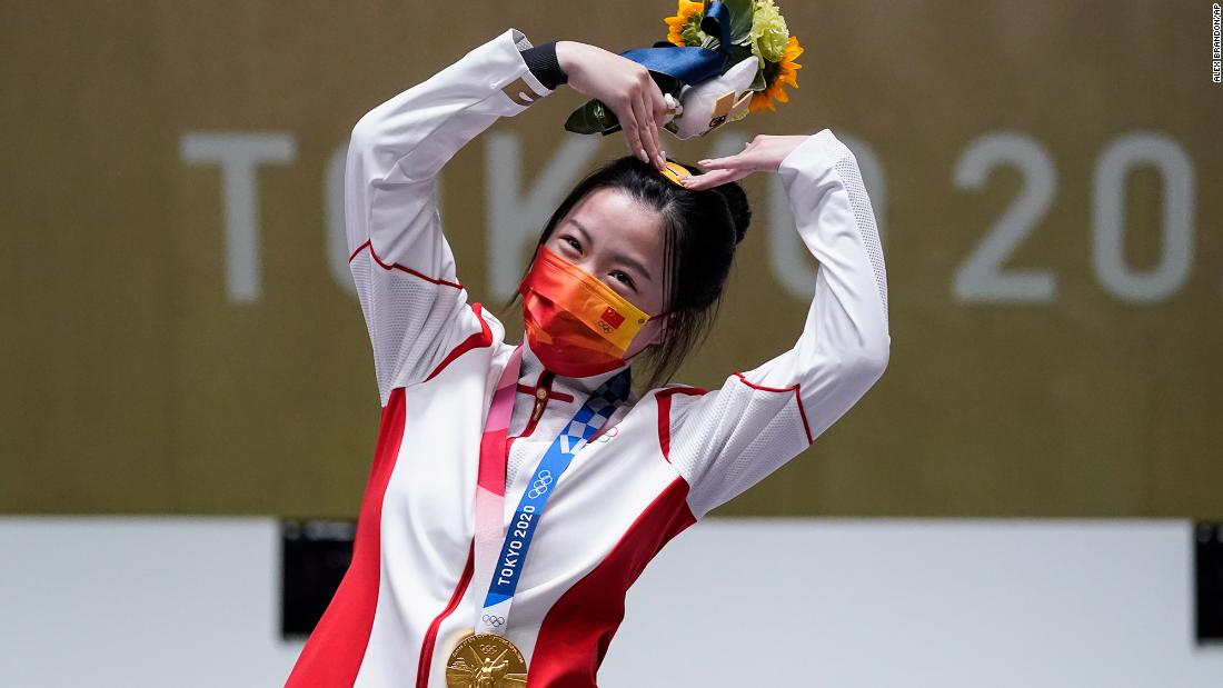 China&#39;s Yang Qian, the first gold-medal winner of these Olympics, celebrates on July 24. She finished first in the 10-meter air rifle.
