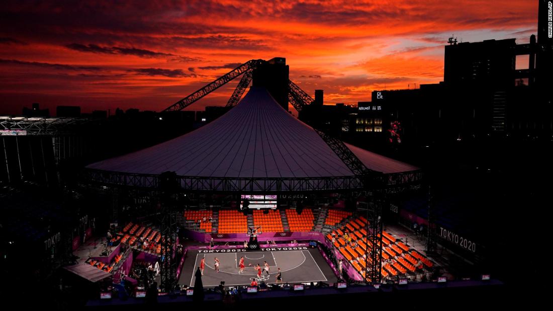 The sun sets in Tokyo on July 26 as Belgium plays the Netherlands in a men&#39;s 3-on-3 basketball game. The event is making its Olympic debut this year.