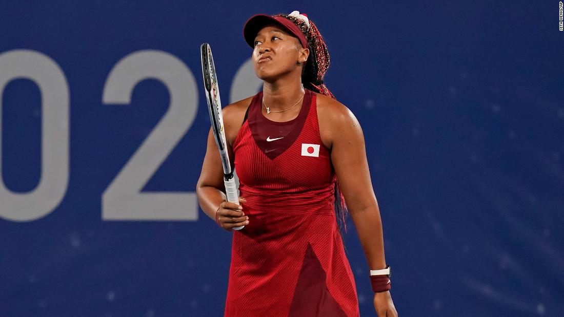 Japanese tennis star Naomi Osaka reacts during &lt;a href=&quot;https://www.cnn.com/2021/07/27/tennis/naomi-osaka-loses-olympics-3rd-round-spt-intl/index.html&quot; target=&quot;_blank&quot;&gt;her third-round loss&lt;/a&gt; to the Czech Republic&#39;s Marketa Vondrousova on July 27. Osaka, who lit the Olympic cauldron during the opening ceremony, had 32 unforced errors in the match. It&#39;s the first time she has lost in a hard-court tournament since the 2020 Australian Open.