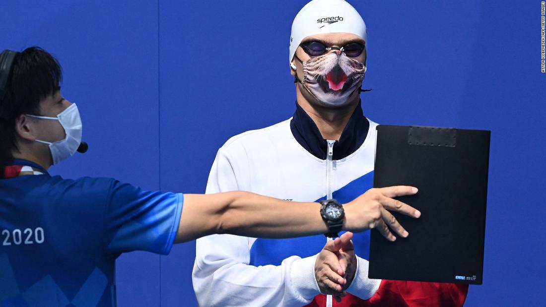 Russian swimmer Evgeny Rylov wears a cat-themed mask as he waits to receive his gold medal on July 27. &lt;a href=&quot;https://www.cnn.com/world/live-news/tokyo-2020-olympics-07-26-21-spt/h_ca80c586169141bbb5c36a560e96b1cf&quot; target=&quot;_blank&quot;&gt;Rylov won the 100-meter backstroke.&lt;/a&gt;