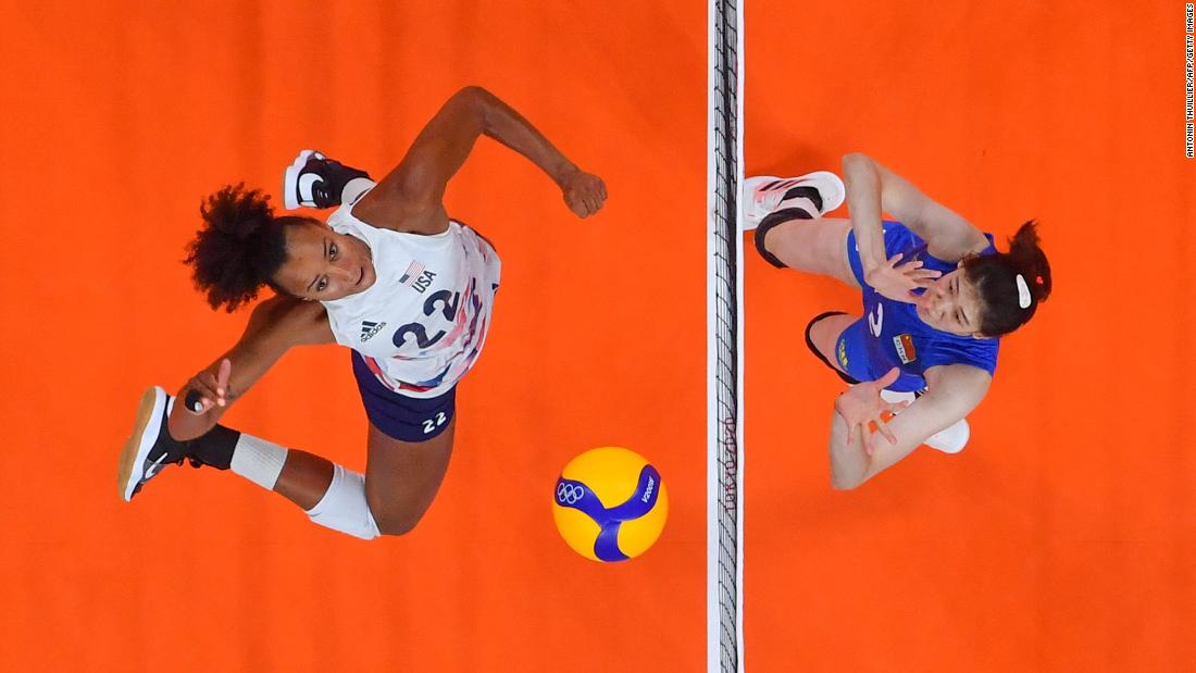 American Haleigh Washington, left, spikes the ball during a volleyball match against China on July 27. The United States won in straight sets, 29-27, 25-22, 25-21.