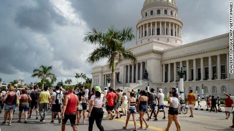 Cubans march in front of Havana&#39;s Capitol during a demonstration against the government of Cuban President Miguel Diaz-Canel in Havana, on July 11, 2021. 