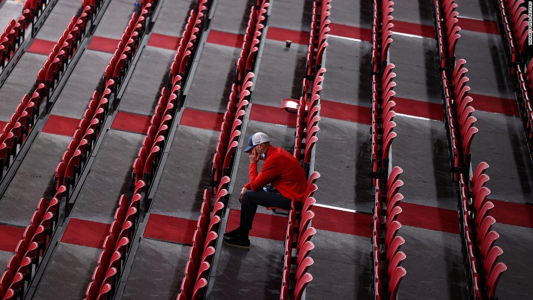 A man sits among rows of empty seats as he watches table tennis at the Tokyo Metropolitan Gymnasium on July 27.