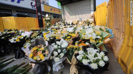 Flowers are placed as tributes in front of Shakou Road subway station in memory of flood victims in Zhengzhou.
