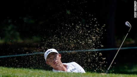 Morikawa plays a shot from a bunker during a practice round of the men&#39;s golf event at the 2020 Summer Olympics.
