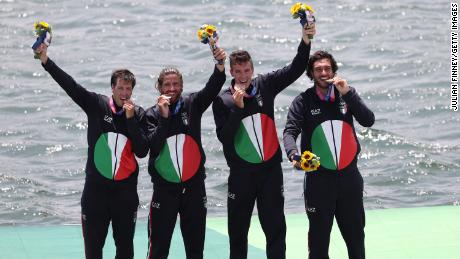 Bronze medalists Matteo Castaldo, Marco di Costanzo, Matteo Lodo and Giuseppe Vicino of Italy bite their medals during the medal ceremony.