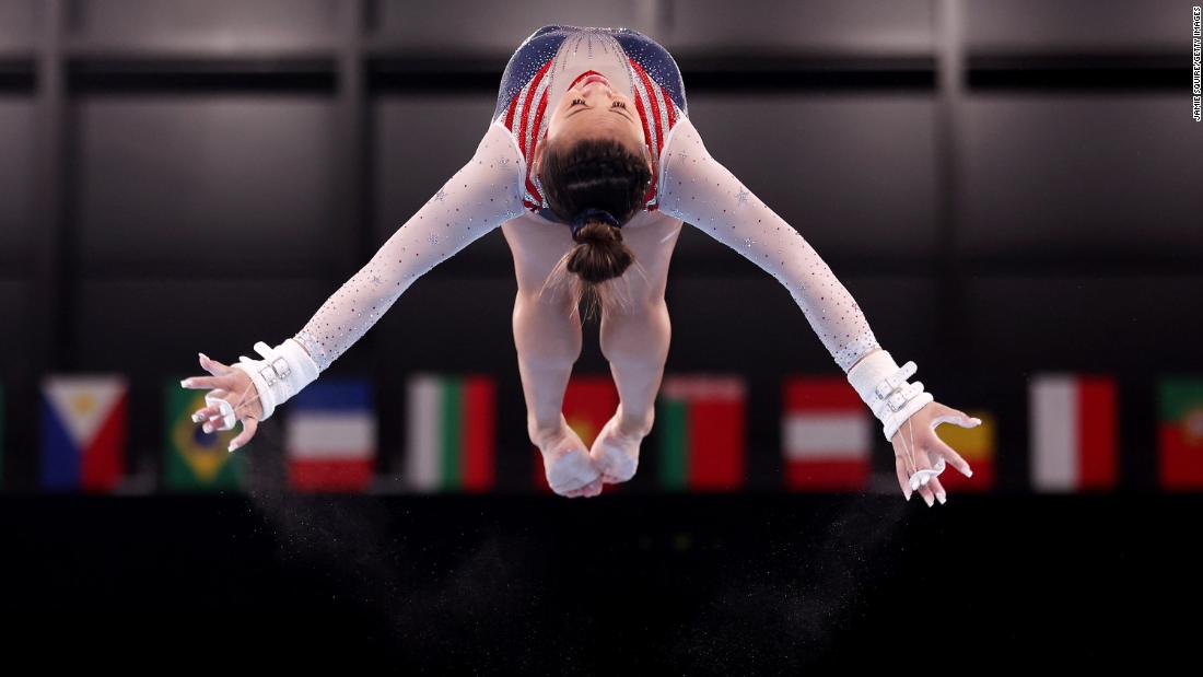 Lee soars in the air during the uneven bars.