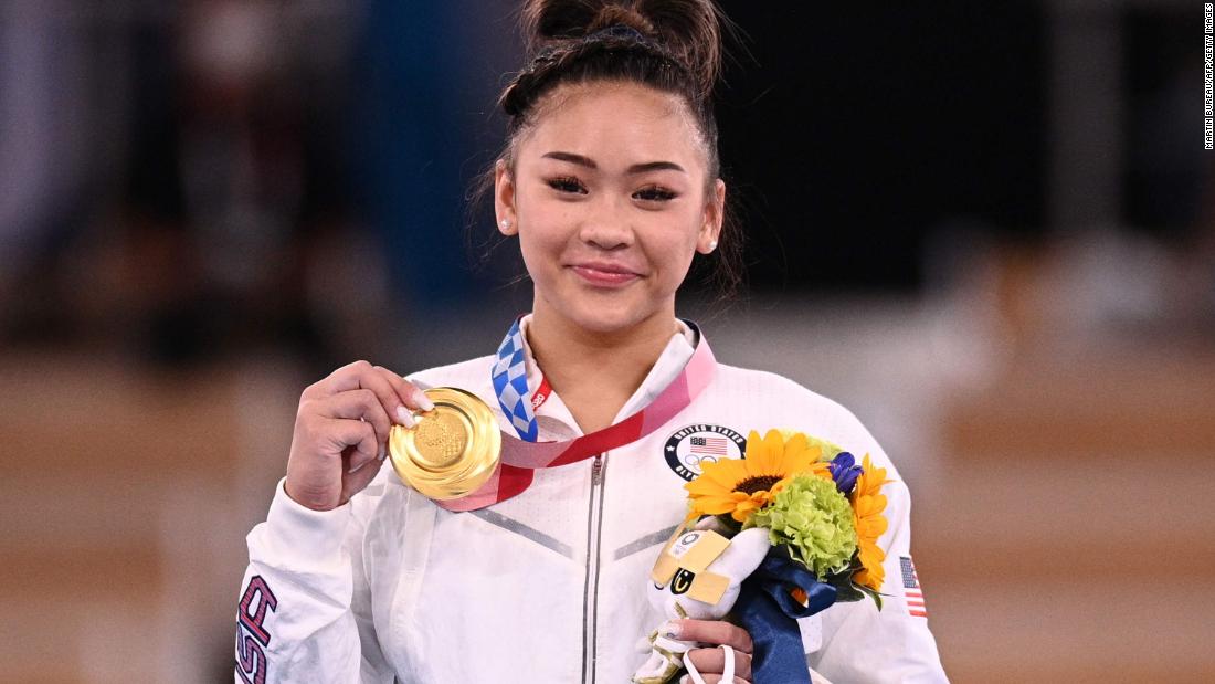 Lee poses with her gold medal on the podium.