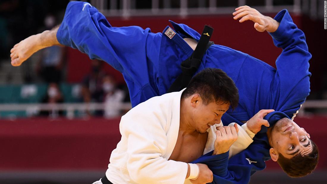 Japan&#39;s Shoichiro Mukai, left, and Germany&#39;s Eduard Trippel compete in team judo on July 31.