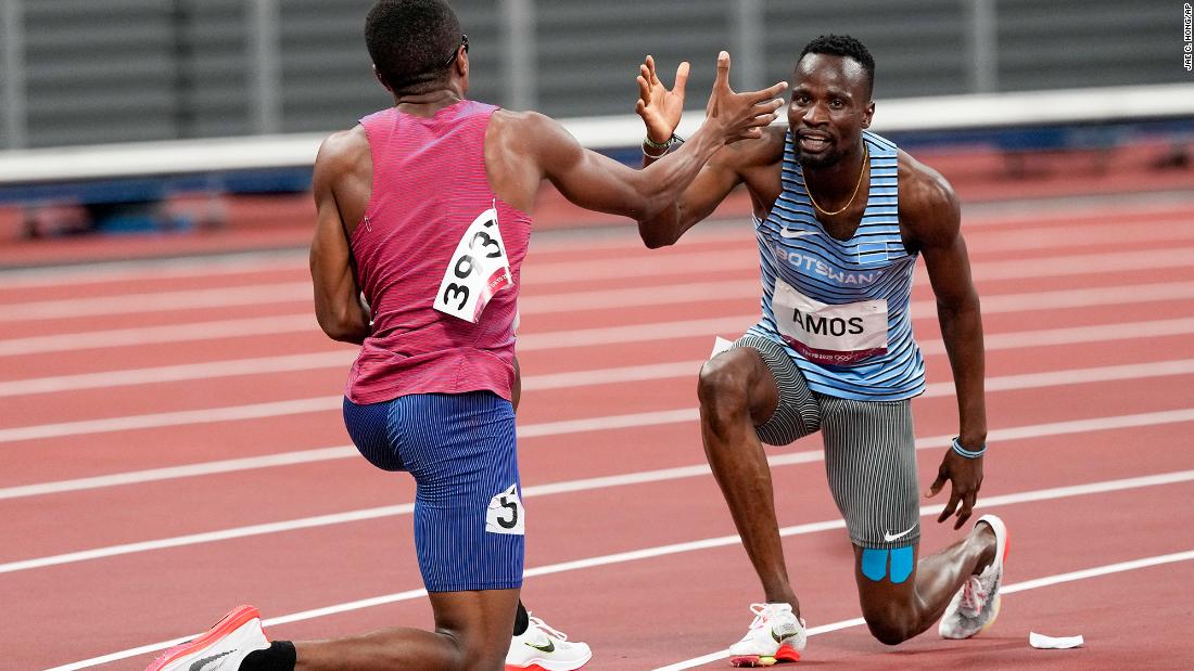 The United States&#39; Isaiah Jewett, left, and Botswana&#39;s Nijel Amos help each other to their feet after falling during an 800-meter semifinal on August 1. They embraced and went on to finish the race together. 
