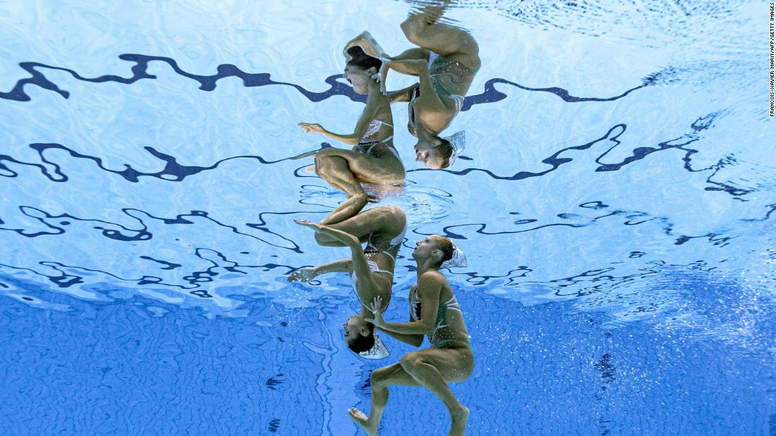This photo, taken underwater, shows Greece&#39;s Evangelia Papazoglou and Evangelia Platanioti competing in artistic swimming on August 2. Artistic swimming used to be called synchronized swimming at the Olympics.