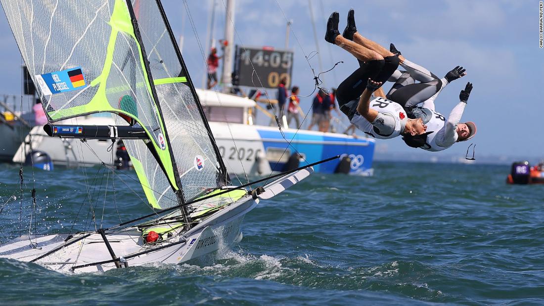German sailors Erik Heil and Thomas Ploessel jump into the water as they celebrate winning bronze in the 49er category on August 3.