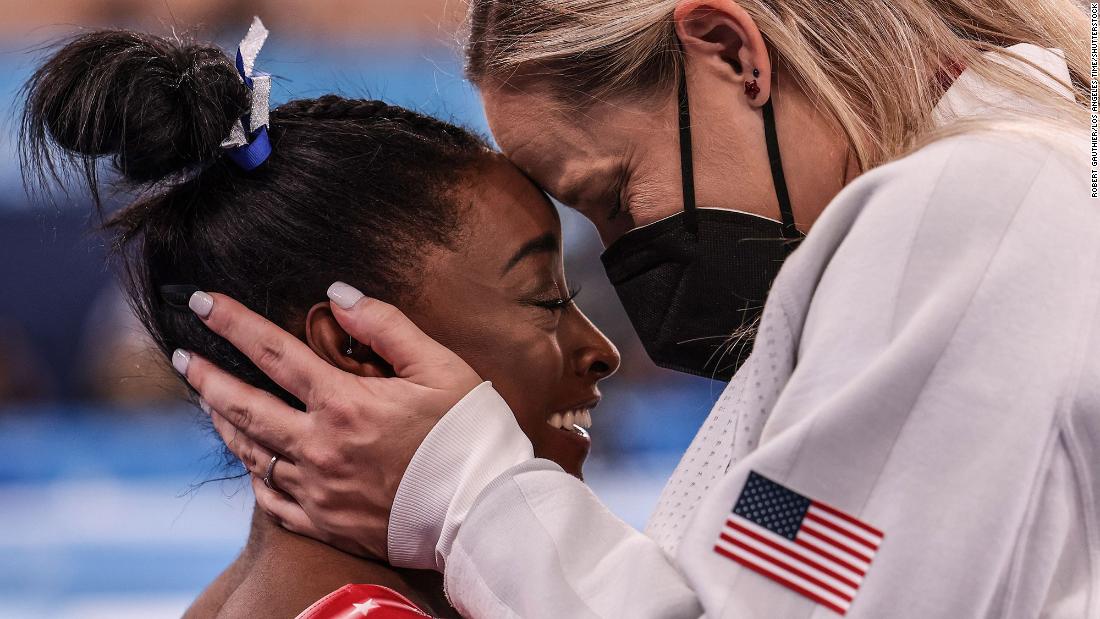 US gymnast Simone Biles is congratulated by coach Cecile Canqueteau-Landi as it became evident that Biles would earn a medal on August 3. Biles now has seven Olympic medals, tying her with Shannon Miller for the most by an American gymnast.