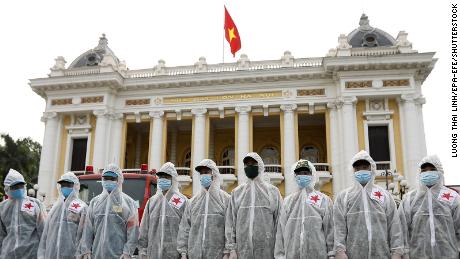 Soldiers from the High Command of Chemicals under Vietnam&#39;s Ministry of National Defence before spraying disinfectant throughout the streets of Hanoi on July 26.