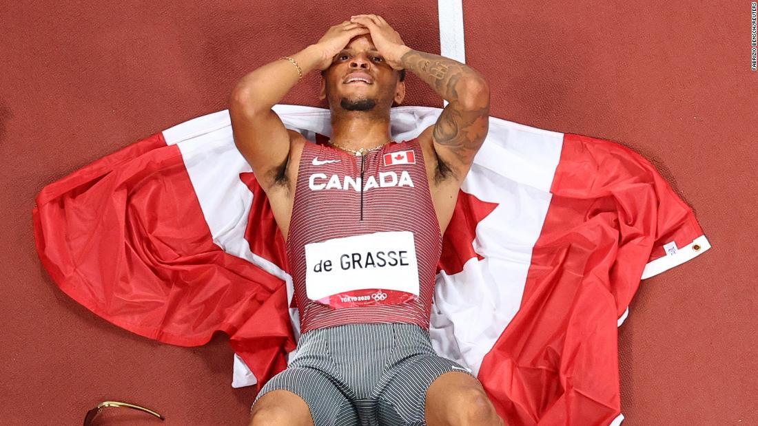 Canadian sprinter Andre De Grasse lies on the track after &lt;a href=&quot;https://www.cnn.com/world/live-news/tokyo-2020-olympics-08-04-21-spt/h_329822ffaa1cc67218da92bea7a9c900&quot; target=&quot;_blank&quot;&gt;winning the 200-meter final&lt;/a&gt; on August 4. It&#39;s the first Olympic gold for De Grasse, who won bronze in the 100 this year and was the silver medalist in the 200 five years ago.