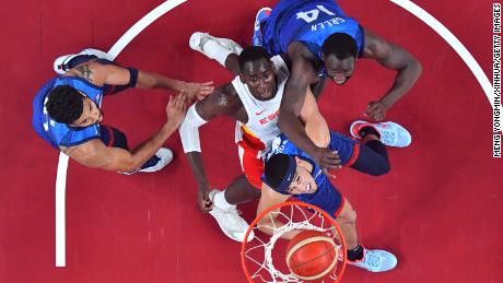 Usman Garuba 2nd L of Spain competes with Devin Booker 2nd R and Draymond Green 1st R of the United States during the men&#39;s basketball quarterfinal match between Spain and the United States. 