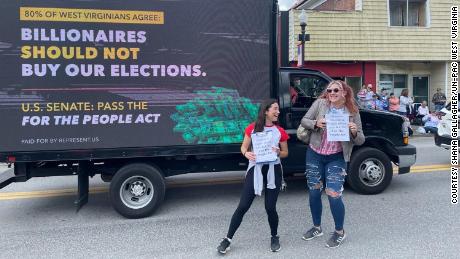 Organizers Shana Gallagher and Rylee Haught pose with a pro-For The People Act truck at the Grafton Memorial Day parade. 