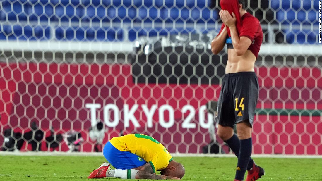 Brazilian defender Dani Alves, left, and Spanish midfielder Carlos Soler react after &lt;a href=&quot;https://www.cnn.com/world/live-news/tokyo-2020-olympics-08-07-21-spt/h_bbe049a5800eb5f90d4e598956a6dd58&quot; target=&quot;_blank&quot;&gt;Brazil defeated Spain&lt;/a&gt; 2-1 in the gold-medal football match on August 7. Brazil is the fifth men&#39;s team in history to win back-to-back titles at the Olympics.