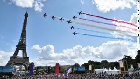The French Air Force aerobatic team - 'Patrouille de France' - flies over the Trocadéro fan village located in front of the Eiffel Tower on August 8, 2021.