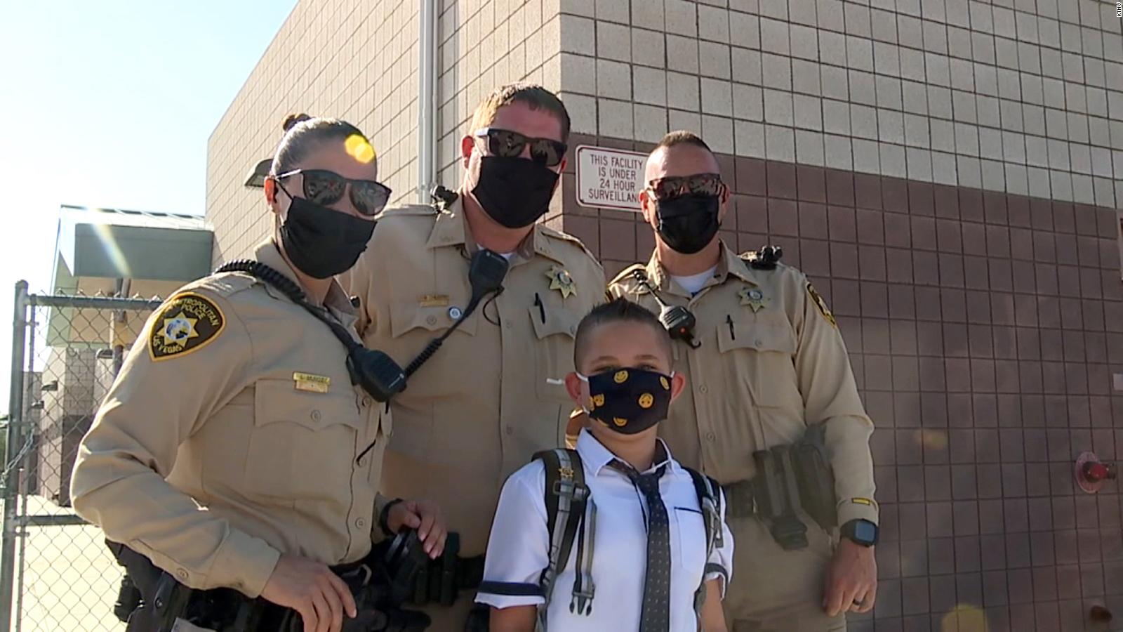 His dad, a police officer, died from Covid-19. Fellow officers escorted him to his first day of school