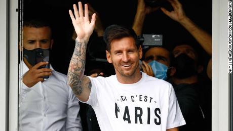 Messi waves to supporters from a window after he landed in Paris on August 10, 2021.