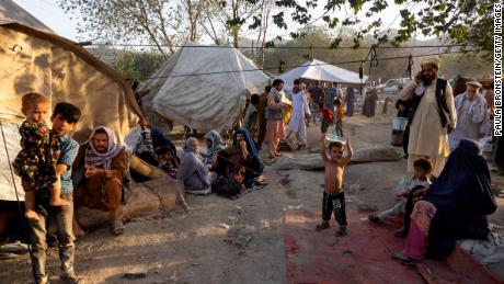 Displaced Afghans arrive at a makeshift camp in Kabul on  August 10, 2021.