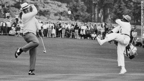 Jack Nicklaus and his caddy celebrate a birdie on the 15th hole on their way to winning the 1966 Masters.