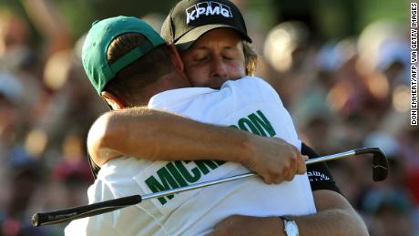 Mickelson hugs his caddie Jim &quot;Bones&quot; Mackay after sinking his putt on the 18th hole to win the 2010 Masters.