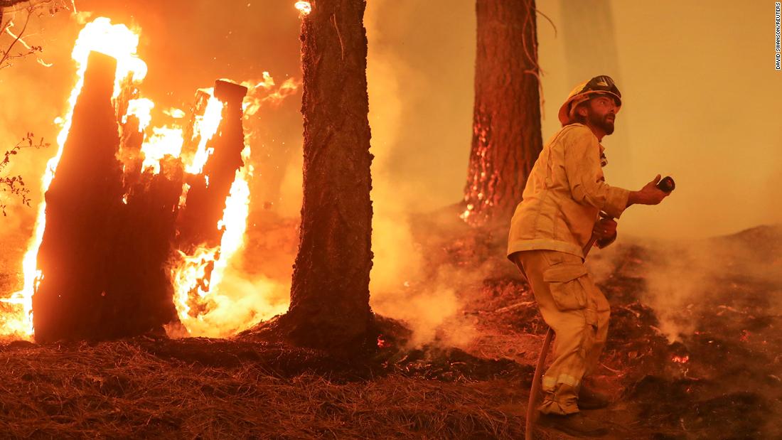 A firefighter battles the Dixie Fire near Taylorsville, Kalifornië, op Augustus 10.