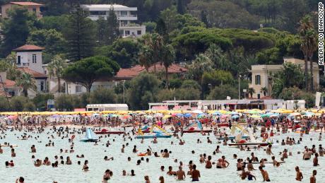 People cool down in the sea in Sicily&#39;s Palermo on Wednesday.