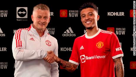 Jadon Sancho shakes hands with Manchester United manager Ole Gunnar Solskjaer after signing with the club. 