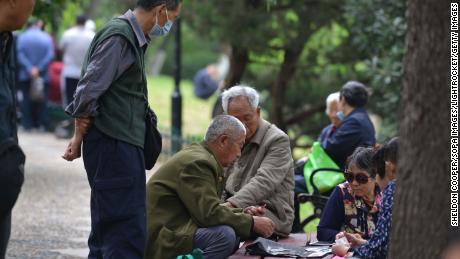 Senior citizens sit together while playing cards in Fuyang, China&#39;s Anhui province, on May 12.