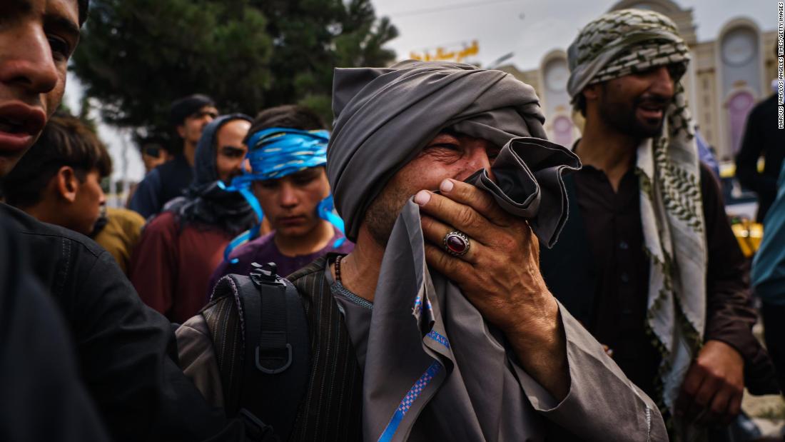 A man reacts as he watches Taliban fighters use violence to control a crowd outside the airport on August 17. At least a dozen people were wounded in the incident, &lt;a href =&quot;https://www.latimes.com/world-nation/story/2021-08-17/snapshot-of-suffering-afghans-trying-to-reach-airport-are-penned-up-beaten-by-taliban&quot; 目标=&quot;_空白&amp报价t;&gt;according to the Los Angeles Times.&ltp;lt;/一个gtmp;gt;