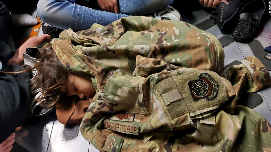 In this photo released by the US Air Force, an Afghan child sleeps on the floor of an Air Force transport plane during an evacuation flight out of Kabul on August 15.