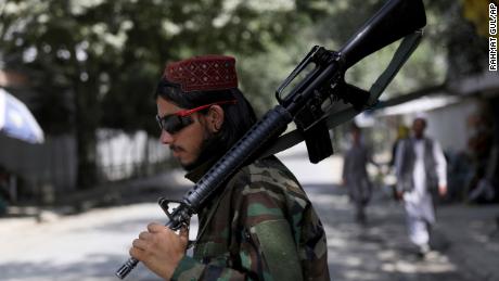 A Taliban fighter stands guard at a checkpoint in the Wazir Akbar Khan neighborhood in the city of Kabul, Afghanistan, Sunday, Aug. 22, 2021.