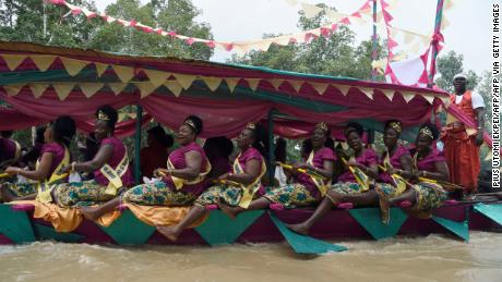 Women dance in a regatta to mark the coronation of Prince Tsola Emiko as the 21st king or the Olu of Warri kingdom and the Ogiame Atuwatse 111 at Ode Itsekiri.