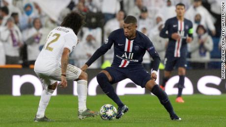 Mbappe dribbles past Real Madrid&#39;s Marcelo during the  Champions League.