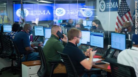 People work inside the Federal Emergency Management Agency&#39;s headquarters in Washington, DC, on Sunday.