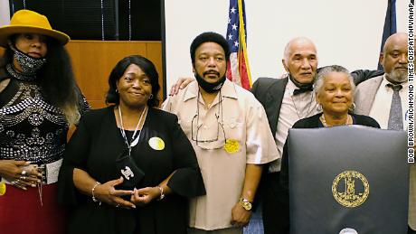 Martinsville Seven family and friends from left, Rose Grayson, Faye Holland, Ron McCollum, James Grayson, Pamela Hairston and Rudy McCollum, pose for a photo before Virginia Gov. Ralph Northam signed posthumous pardons Tuesday.