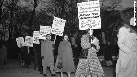 In this Jan. 30, 1951 file photo, demonstrators march in front of the White House in Washington, in what they said was an effort to persuade President Harry Truman to halt execution of the seven men.