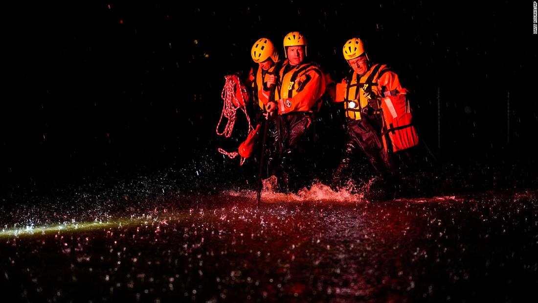 Members of the Weldon Fire Company walk through floodwaters in Dresher, Pennsylvania, a settembre 1.